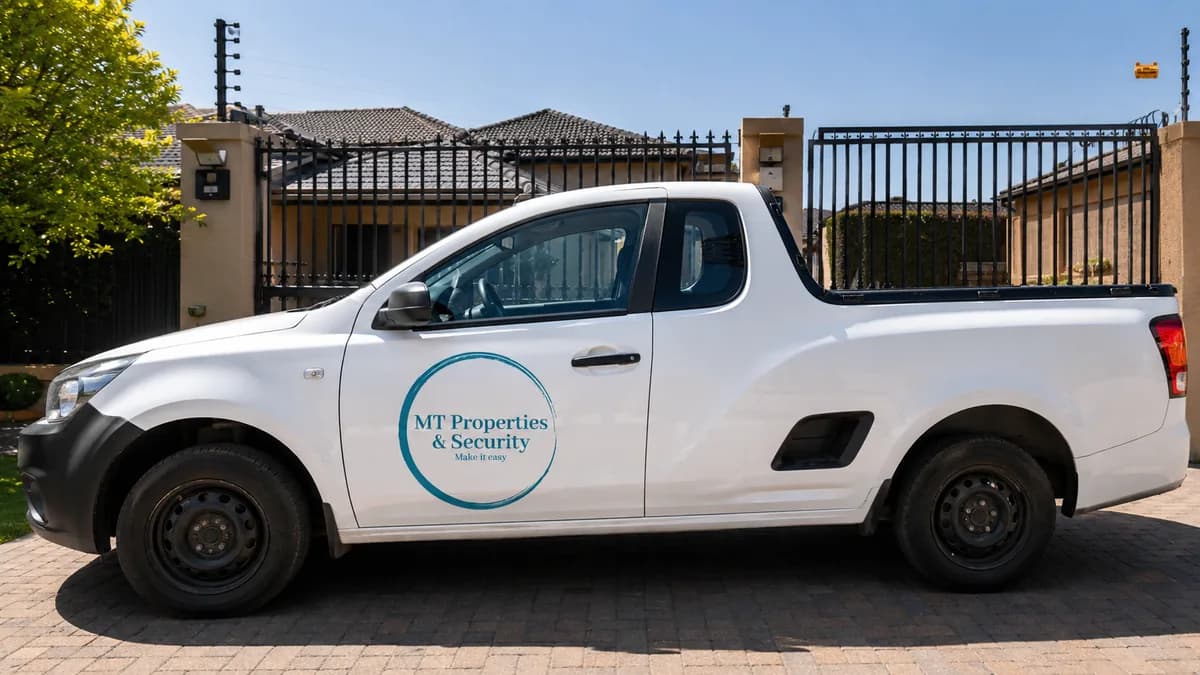 MT Properties & Security branded vehicle parked outside a secured property